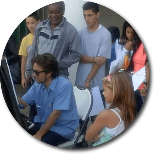 San Diego caricaturist Cameron Canales drawing a crowd at a local church event in North County San DIego, Oceanside.